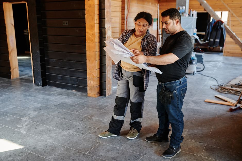 Professional contractor reviewing kitchen blueprints