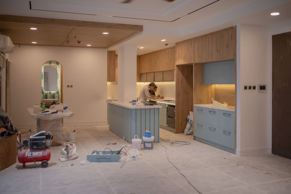 Craftsman installing custom kitchen cabinets